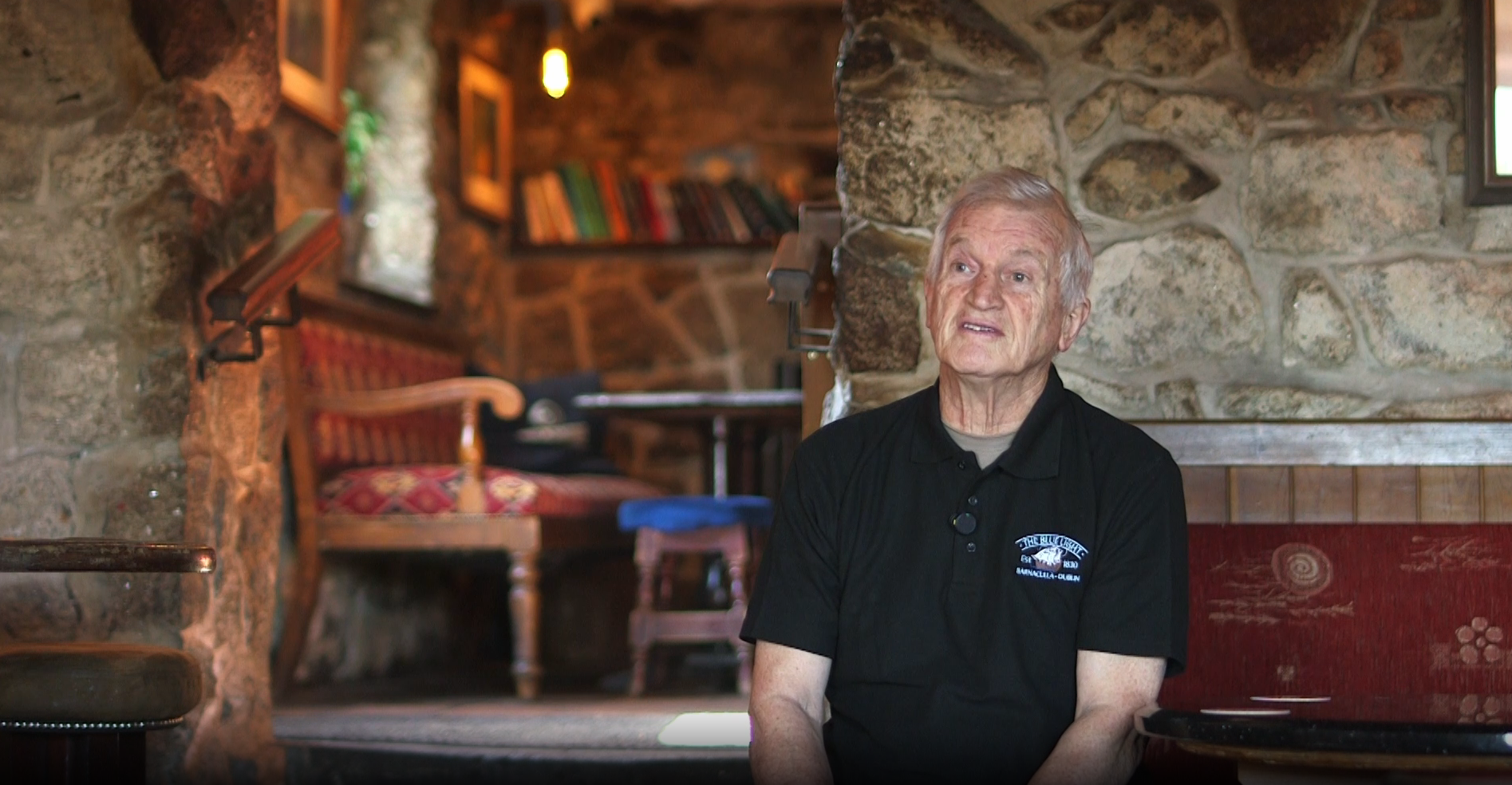The pub's owner mid sentence during the interview, seated in the stone walled bar