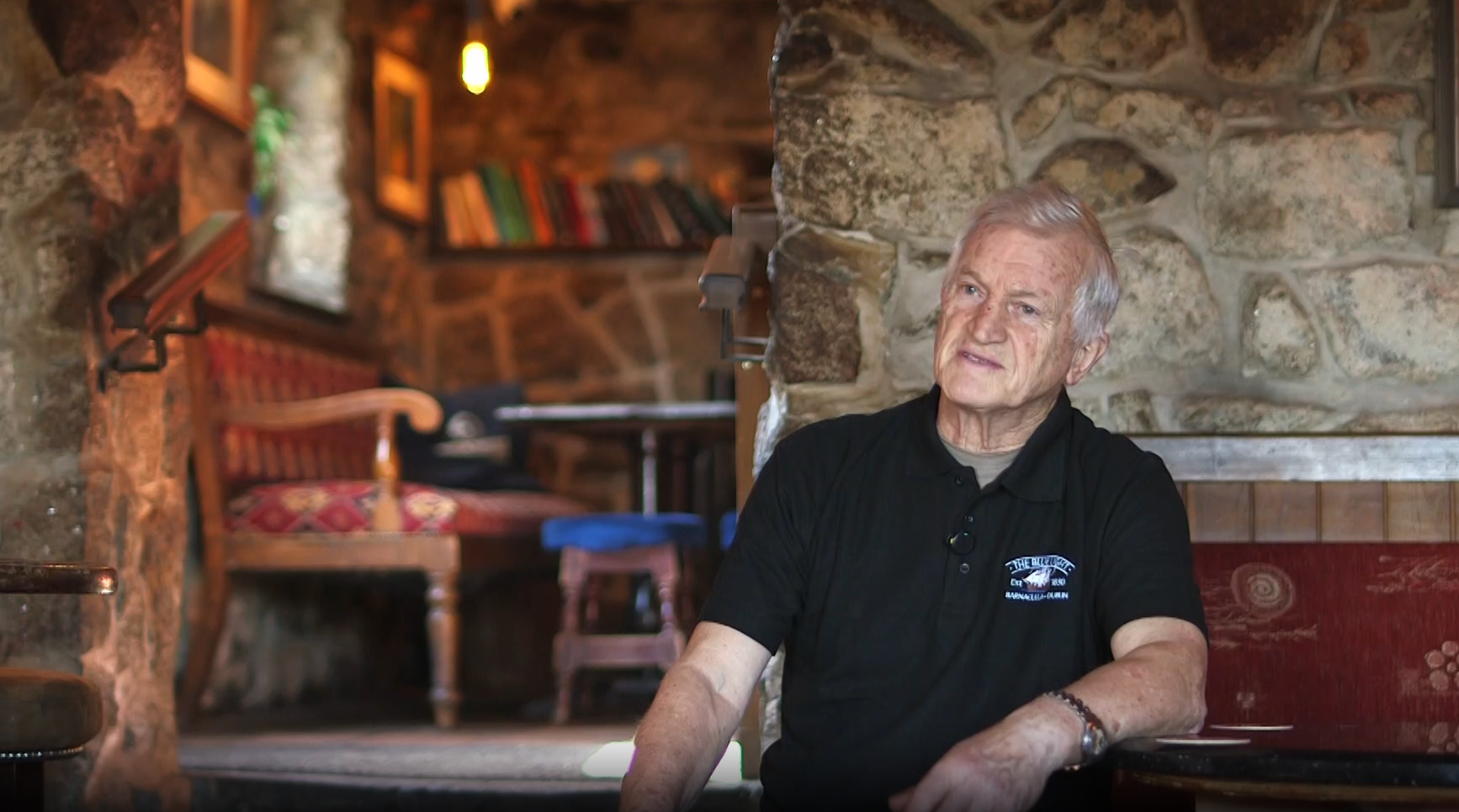 A still from the Blue Light Pub documentary: the owner being interviewed in the bar